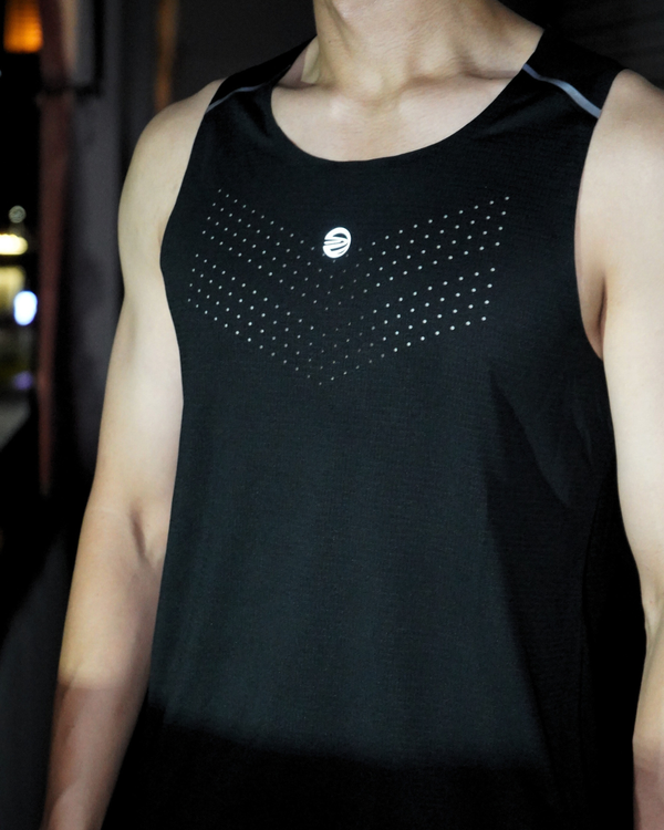 Person wearing a black pulse tank top with a brand logo on a blurred background